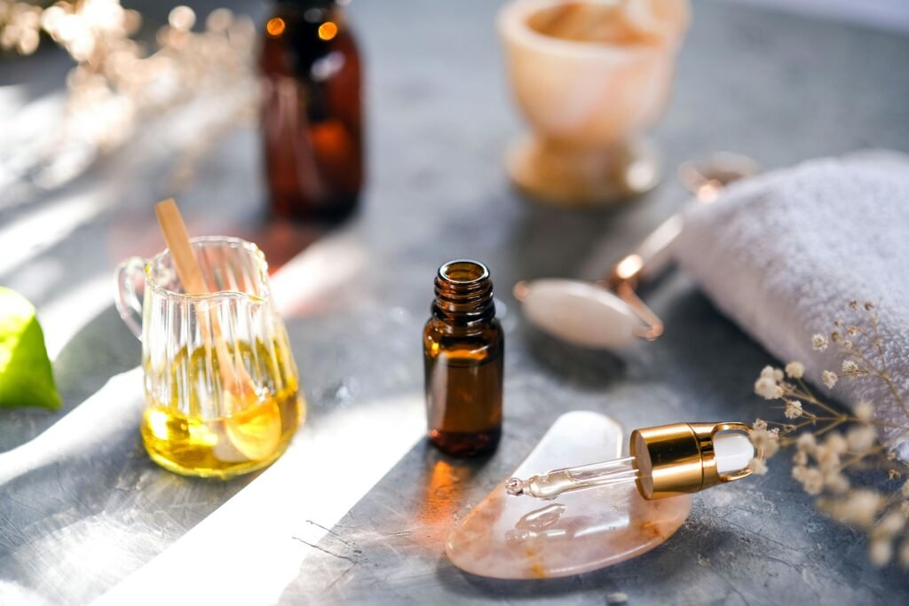Aromatic oils and spa tools arranged on a table, perfect for relaxation.