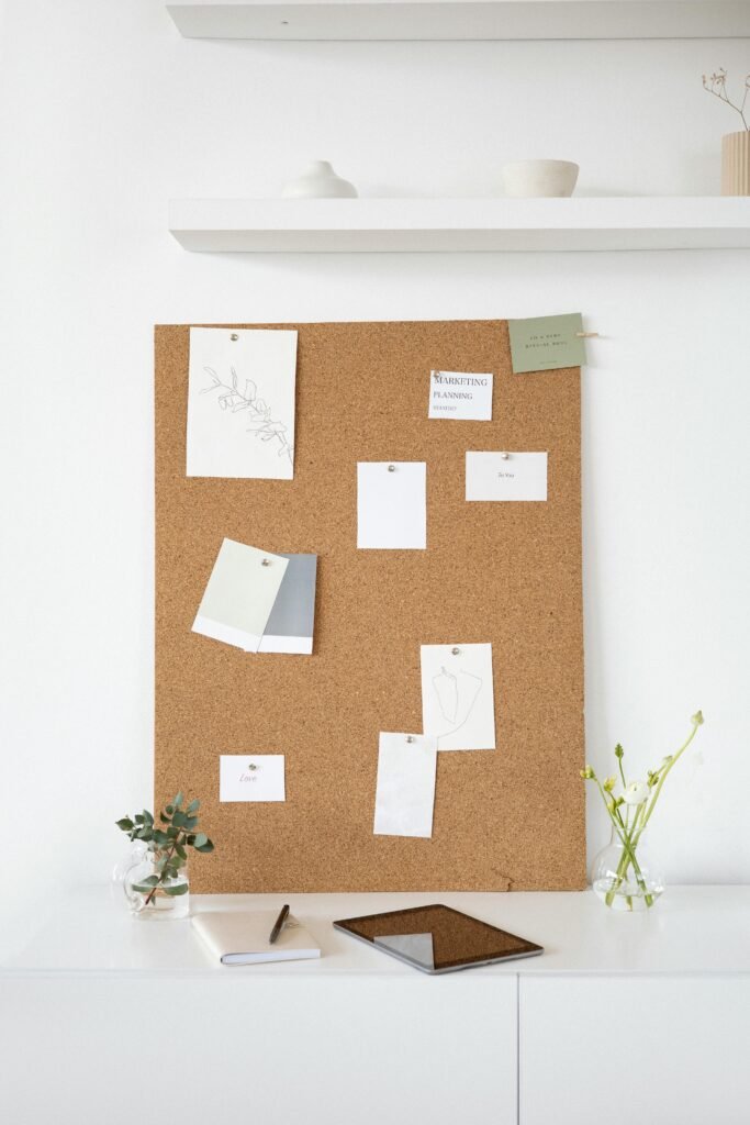 A clean and creative workspace featuring a cork board with notes, ideal for inspiration and design planning.